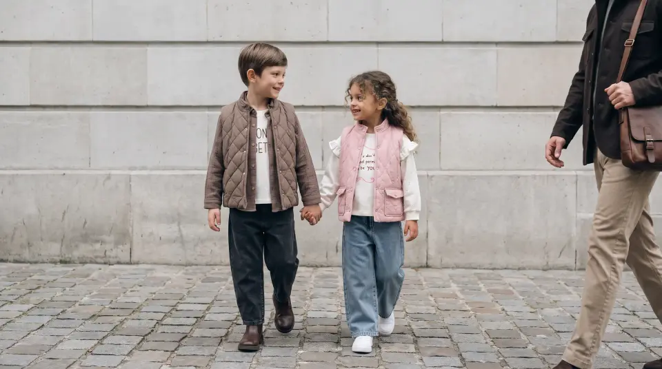 Taş duvar önünde el ele yürüyen iki çocuk, Ecoo Kids sonbahar-kış koleksiyonu